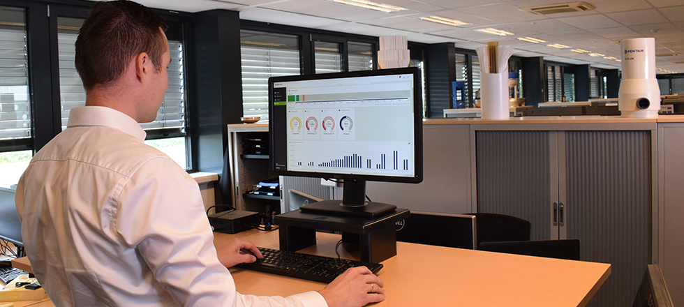 Employee looking at graphs on screen